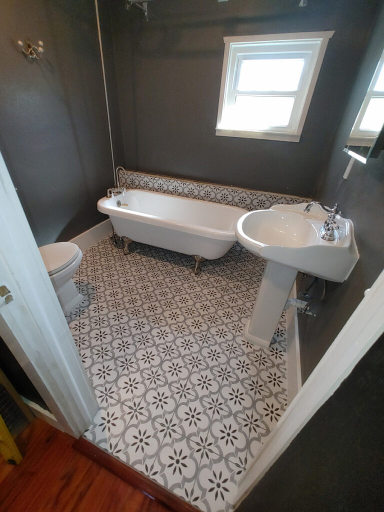 Services 13 bathroom with black and white tile and claw foot tub